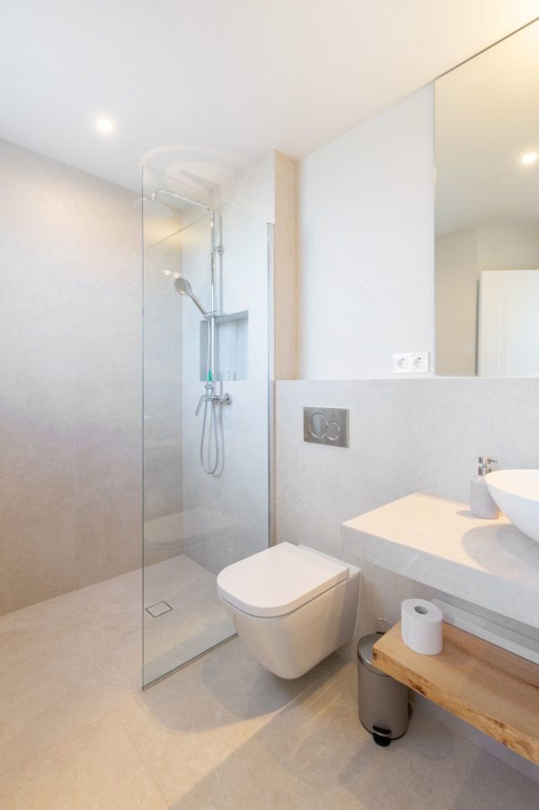 Renovated bathroom with shower and white toilet