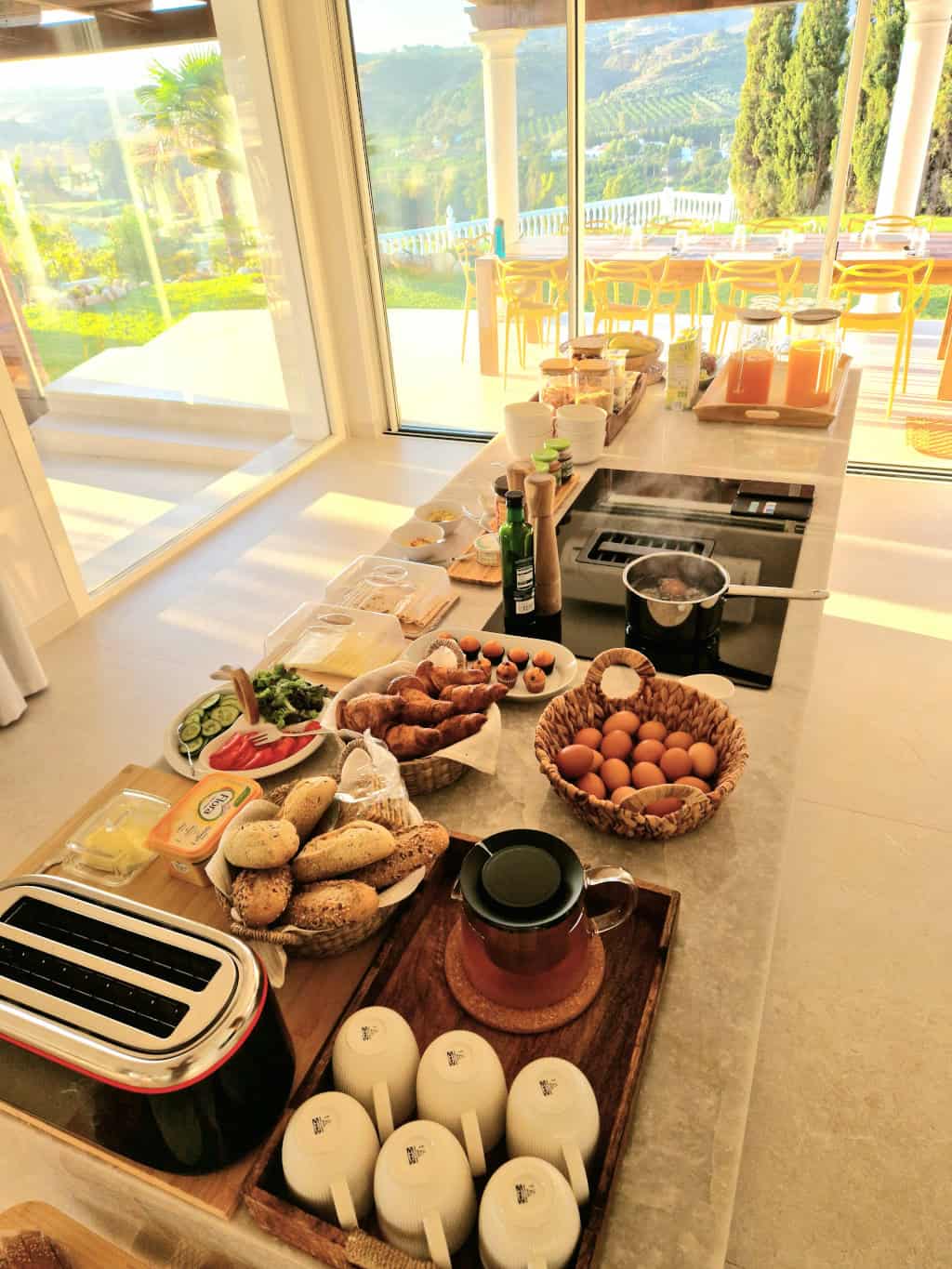 Kitchen table with breakfast, sun is shining thru windows