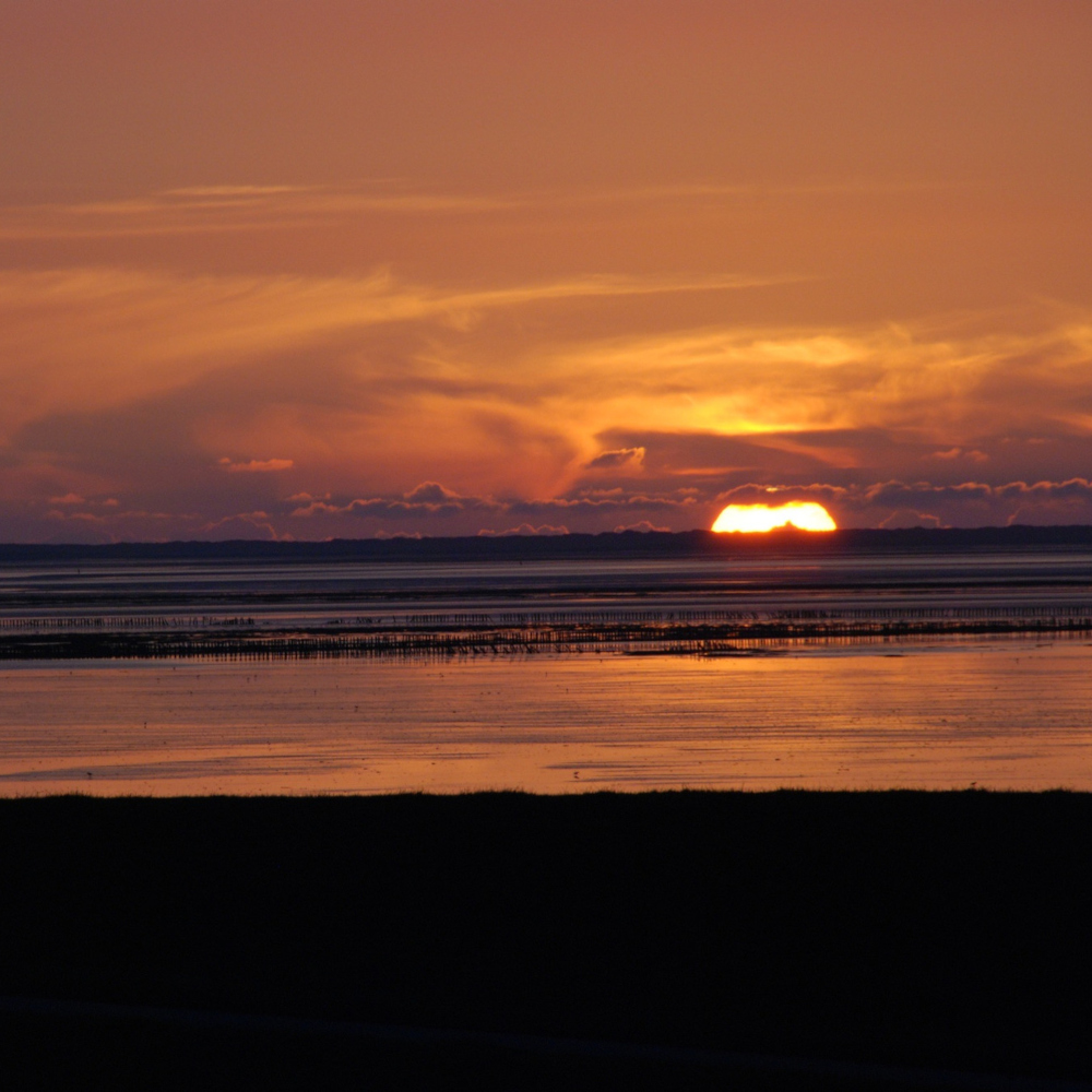 Sunset with clouds at Friesland's coast