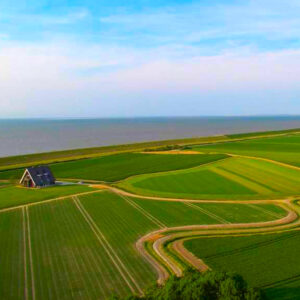Dutch house in gras field drone picture, blue sky with some clouds