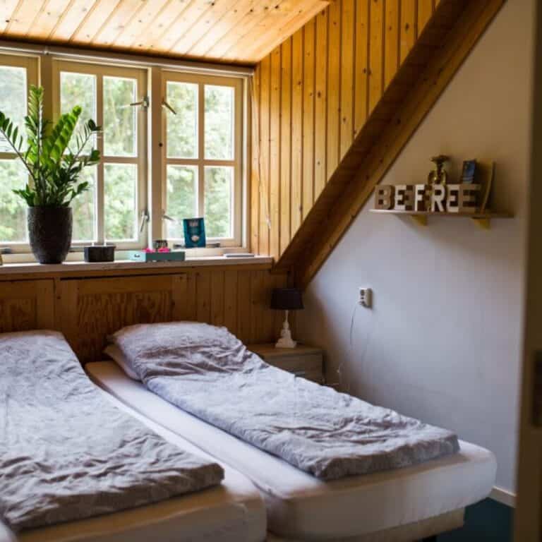 Bedroom with a couples bed, sun shines into the room