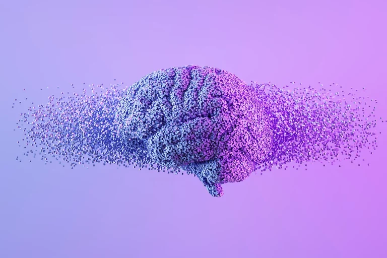 A digital rendering of a brain dissolving into numerous small particles, set against a purple gradient background, illustrating the concept of memory loss or cognitive decline.